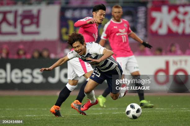 Yun Il-Lok of Yokohama F.Marinos is challenged by Hotaru Yamaguchi of Cerezo Osaka during the J.League J1 match between Cerezo Osaka and Yokohama...