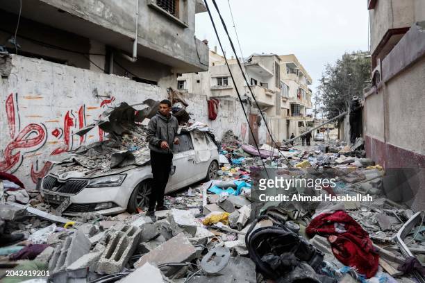 People inspect damage and recover items from their homes following Israeli air strikes on February 27, 2024 in Rafah, Gaza. As of Tuesday 878 had...