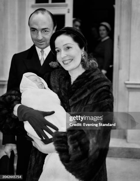 Actress Valerie Hobson holding her baby David Profumo while her husband, politician John Profumo stands behind them, November 14th 1955.