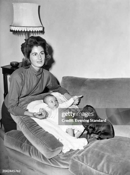 Lady Annabel Birley with her baby son Rupert and a Dachshund dog, November 17th 1955.