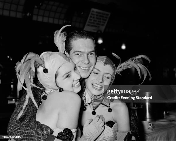 American singer Johnnie Ray with two of The Tiller Girls during rehearsals for the Royal Variety Performance, Victoria Palace Theatre, London,...