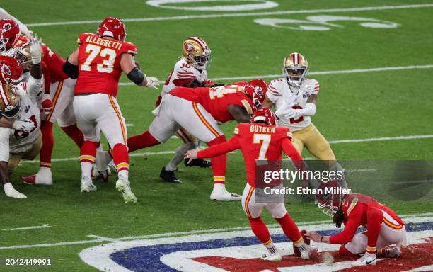 Punter Tommy Townsend of the Kansas City Chiefs holds for place kicker Harrison Butker as he kicks a 57-yard field goal against the San Francisco...