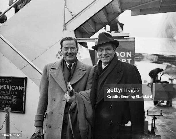 Actor Laurence Olivier , right, with playwright Terence Rattigan at London Airport, February 16th 1957. Both had returned from a trip to New York.