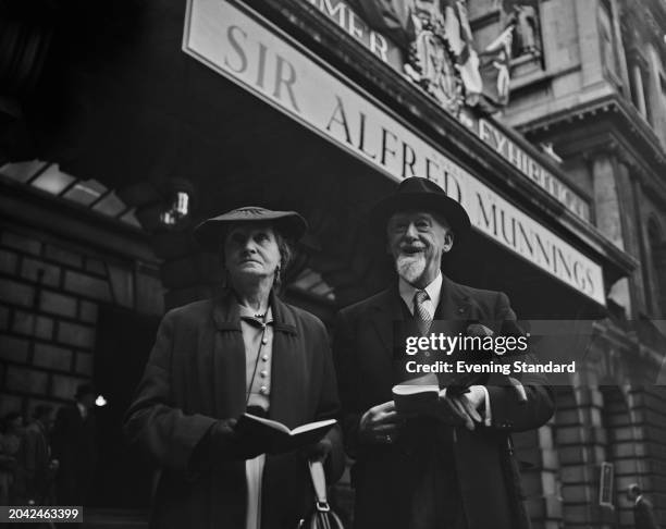 Art historian Thomas Bodkin and his wife Aileen Bodkin stand outside the Royal Academy to attend the Alfred Munnings exhibition, London, May 7th 1956.