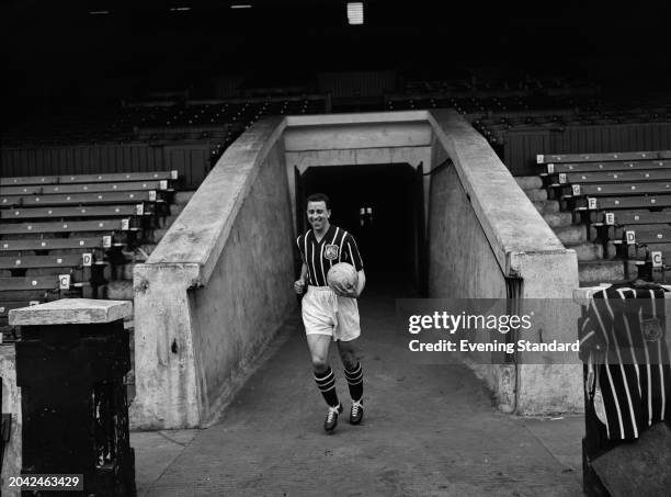 Manchester City Football Club captain Ray Paul runs out of the Maine Road stadium tunnel holding a football, Manchester, April 25th 1956. The 1956 FA...