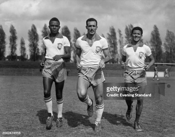 Brazilian footballers from left, defenders Zózimo and Pavão with midfielder Dequinha at Dulwich Hamlet ground, London, during training ahead of an...