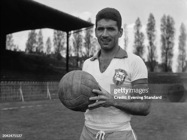 Brazilian football defender Nilton Santos holding a soccer ball at Dulwich Hamlet ground, London, during training ahead of an international Friendly...