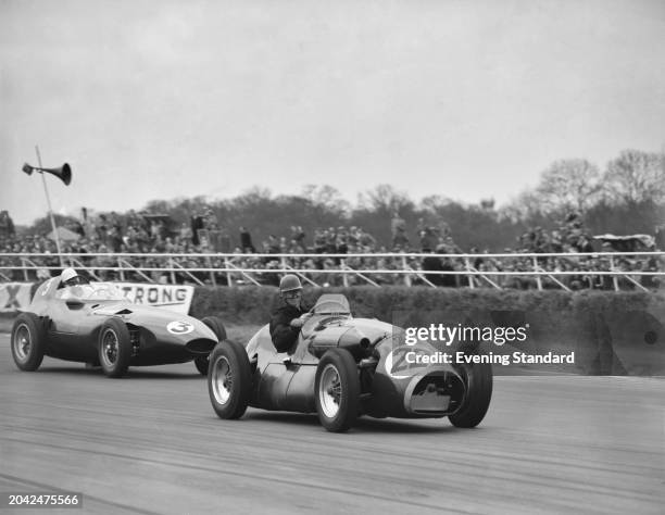 Racing driver Stirling Moss left, in the Vanwall about to overtake Dick Gibson in the Connaught Type A-Lea Francis race car at the 8th Annual BRDC...