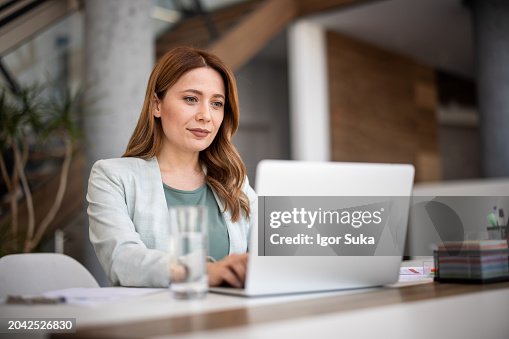 Successful businesswoman using laptop, working in office. Business technology corporate concept Successful businesswoman using laptop, working in office. Business technology corporate concept