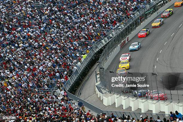 Dale Earnhardt Jr., in the Bud Chevrolet car leads the pack through turn four during the NASCAR Carolina Dodge Dealers 400 on March 16, 2003 at...