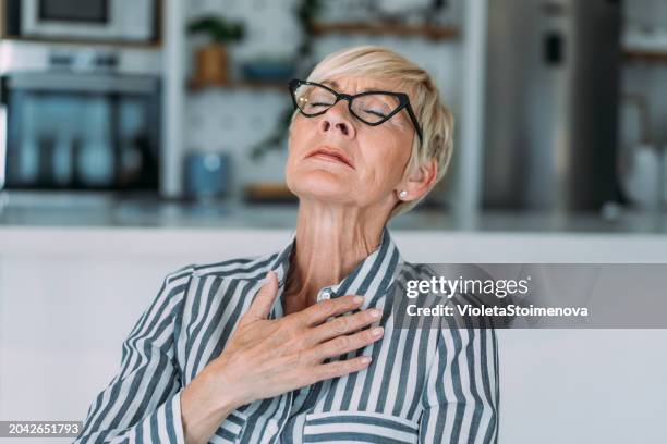 senior woman having heartache. - ischemic heart disease stock pictures, royalty-free photos & images