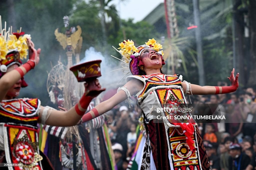 Indonesian Ritual Balinese people perform a ritual dance during a parade of effigies ...