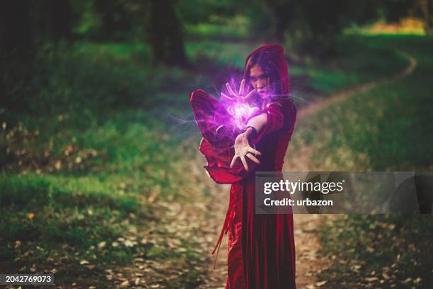 evil witch practicing magic in the forest - pagan magic stock pictures, royalty-free photos & images