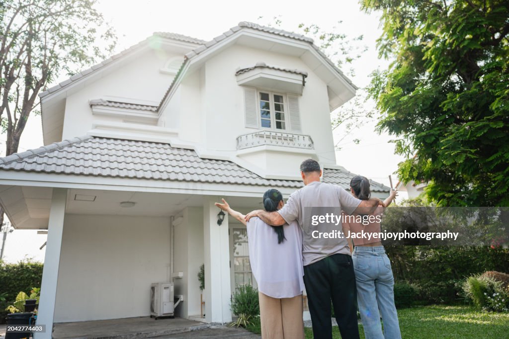 Family portrait in front of their newly constructed, contemporary home