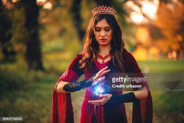 evil witch practicing magic in the forest - wicca stock pictures, royalty-free photos & images