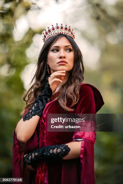 evil queen standing in the forest - evil queen stock pictures, royalty-free photos & images