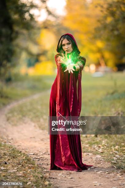 evil witch practicing magic in the forest - wicca stock pictures, royalty-free photos & images