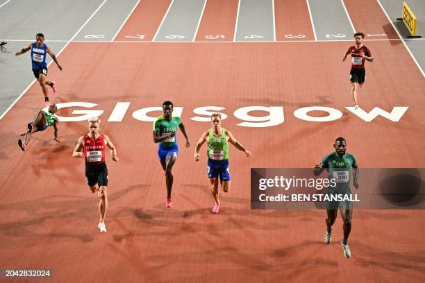 Comoros' Ambdoul Karim Riffayn falls while crossing the finish line with Nauru's Winzar Kakiouea, Denmark's Simon Hansen, Brazil's Felipe Bardi,...