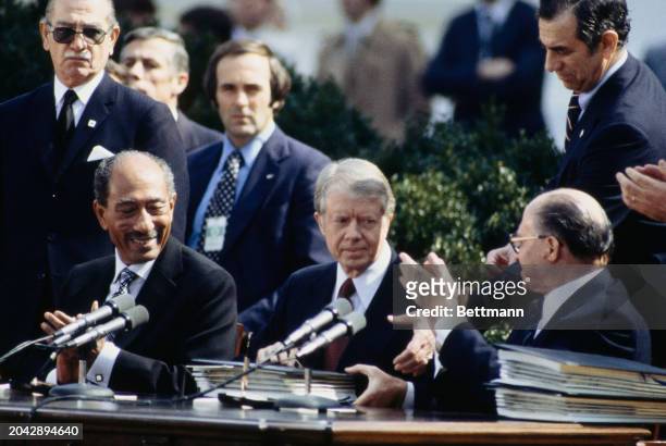 President Jimmy Carter with Egyptian President Anwar Sadat and Israeli Prime Minister Menachem Begin at the signing of the Camp David Accords Peace...