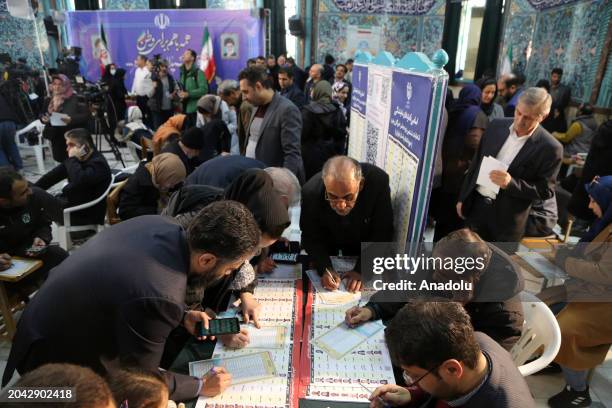 People arrive to cast their votes for 12th term of the parliamentary elections and the 6th term of the Assembly of Leadership Experts at a polling...