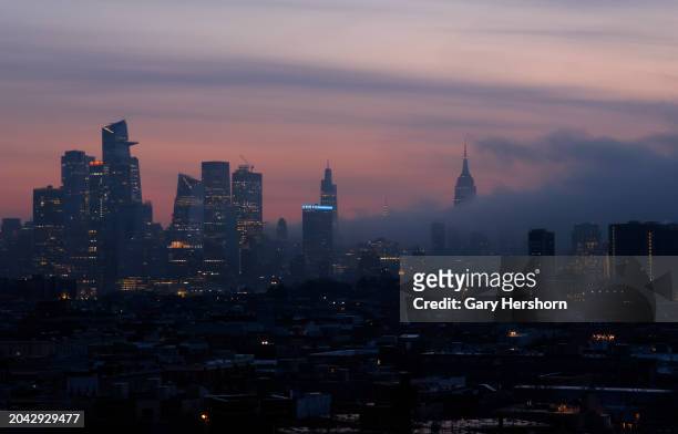 Fog rolls into midtown Manhattan as the sun rises in New York City on February 27 as seen from Jersey City, New Jersey.