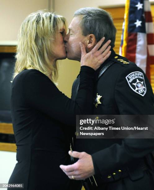 Sheriff Jack Mahar gets a kiss from his wife Selina after being sworn in for a third term by Hon. Michael Melkonian on Monday, Jan. 2, 2012 at the...