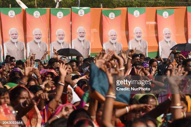 Prime Minister Narendra Modi is waving to supporters, including women BJP supporters, during a rally in Arambagh, Hooghly district, on March 1, 2024.
