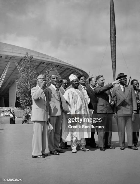 Guide points out items of interest to some of the visitors, including Chief Adegunle Soetan and Sheriff Abdulla Salim, guests of the UK government...