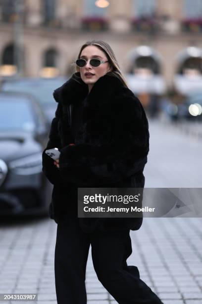 Andra Theobald seen wearing Celine silver oval Triomphe sunglasses, gold necklace, black wool knit sweater, Glamify Fashion black fake fur short...