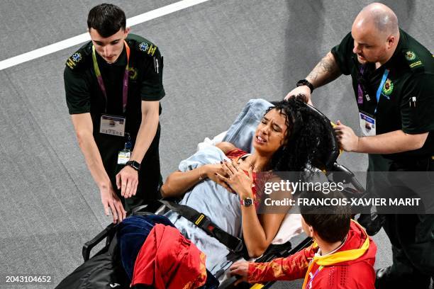 Spain's Maria Vicente is evacuated on a stretcher after hurting herself while competing in the Women's Pentathlon High Jump during the Indoor World...