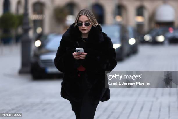 Andra Theobald seen wearing Celine silver oval Triomphe sunglasses, gold necklace, black wool knit sweater, Glamify Fashion black fake fur short...