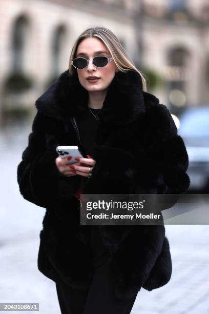 Andra Theobald seen wearing Celine silver oval Triomphe sunglasses, gold necklace, black wool knit sweater, Glamify Fashion black fake fur short...