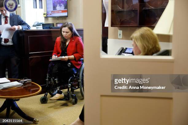 Sen. Tammy Duckworth looks at her notes before the start of a news conference at the U.S. Capitol on protections for access to in vitro fertilization...