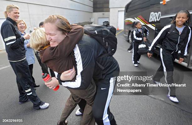 UAlbany basketball player Megan Craig gets a big hug from Cathy Probst of Menands as the UAlbany women's basketball team board their bus at UAlbany...