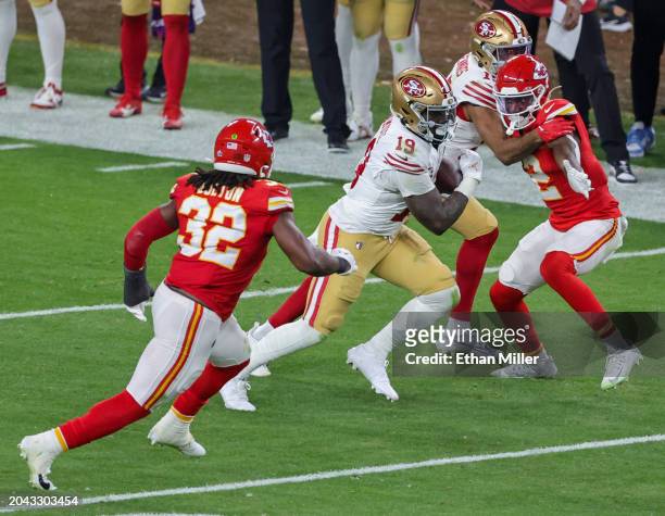 Wide receiver Deebo Samuel of the San Francisco 49ers carries the ball against the Kansas City Chiefs in the third quarter of Super Bowl LVIII at...