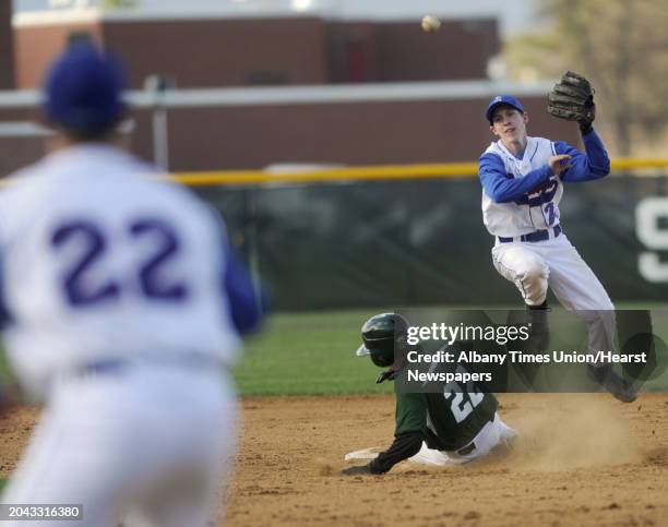 Saratoga's Matt Flynn throws the ball to first base for a double play getting Shenendehowa runner Greg Geisel out at second during a baseball game...