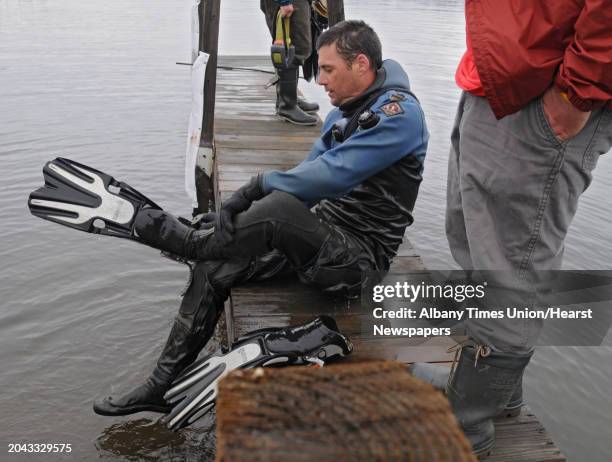 Co-Executive Director for the Lake Champlain Maritime Museum Adam Kane gets out of the water after looking for Asian clams Thursday, May 3, 2012 at...