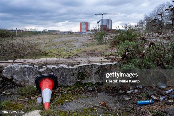 New high rise residential tower block apartment buildings under construction seen beyond waste ground as part of the development / redevelopment near...