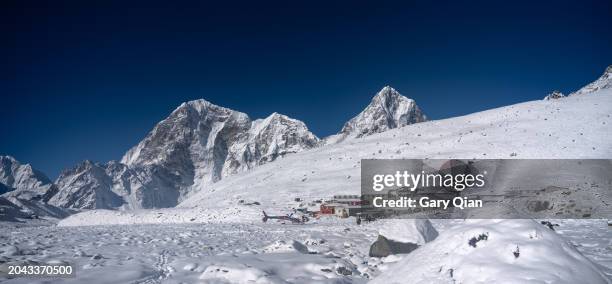 village of gorak shep on the everest base camp trail with a rescue helicopter. - icefall stock pictures, royalty-free photos & images