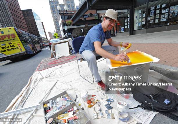 Tony Iadicicco of Albany paints an abstract piece of art on North Pearl street on PARK Day Friday, Sept. 21, 2012 in Albany, N.Y. PARK Day is an...