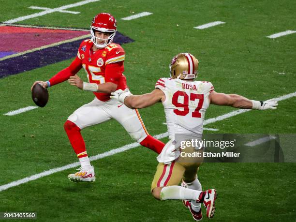 Quarterback Patrick Mahomes of the Kansas City Chiefs looks to throw under pressure from defensive end Nick Bosa of the San Francisco 49ers in the...