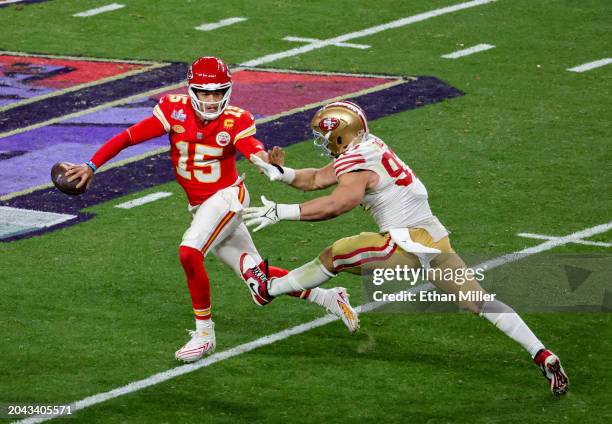 Quarterback Patrick Mahomes of the Kansas City Chiefs looks to throw under pressure from defensive end Nick Bosa of the San Francisco 49ers in the...