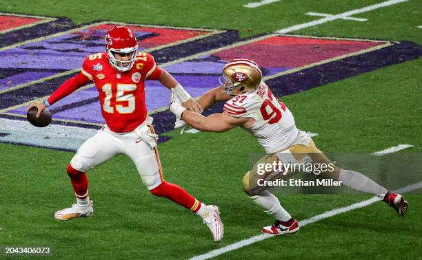 Quarterback Patrick Mahomes of the Kansas City Chiefs looks to throw under pressure from defensive end Nick Bosa of the San Francisco 49ers in the...