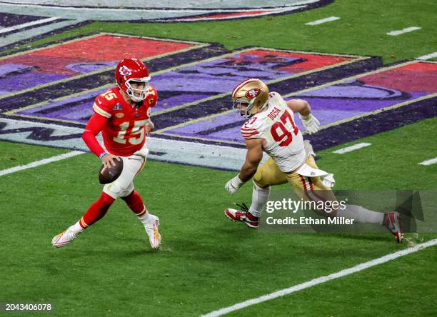 Quarterback Patrick Mahomes of the Kansas City Chiefs looks to throw under pressure from defensive end Nick Bosa of the San Francisco 49ers in the...