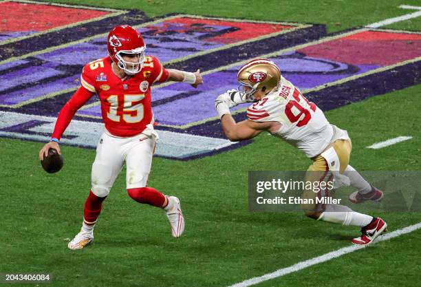 Quarterback Patrick Mahomes of the Kansas City Chiefs looks to throw under pressure from defensive end Nick Bosa of the San Francisco 49ers in the...