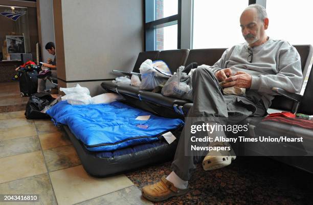 Couple of stranded passengers wait at the Albany-Rensselaer Train Station on Tuesday, Oct. 30, 2012 in Rensselaer, N.Y. Hurricane Sandy caused...