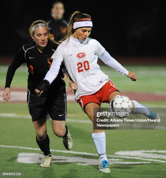 From left, Bethlehem's Elle Lutz battles for the ball with Guilderland's Angela Luizzi during the Class AA Section II girls' soccer finals on...