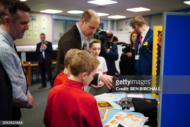Britain's Prince William, Prince of Wales meets pupils during a visit to Ysgol Yr Holl Saint/All Saint's School in Wrexham in north Wales to see how...