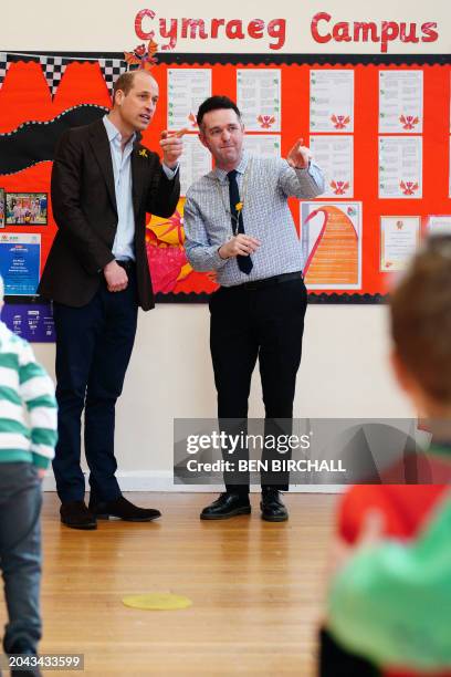 Britain's Prince William, Prince of Wales speaks with Richard Hatwood, the headteacher during his visit to Ysgol Yr Holl Saint/All Saint's School in...