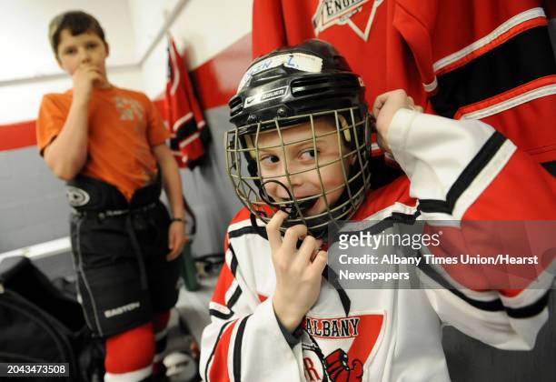 Troy Albany Junior Engineers hockey player Collin Lagios of Guilderland puts on his helmet before playing the Yale Bulldogs of Conn. At the 20th...